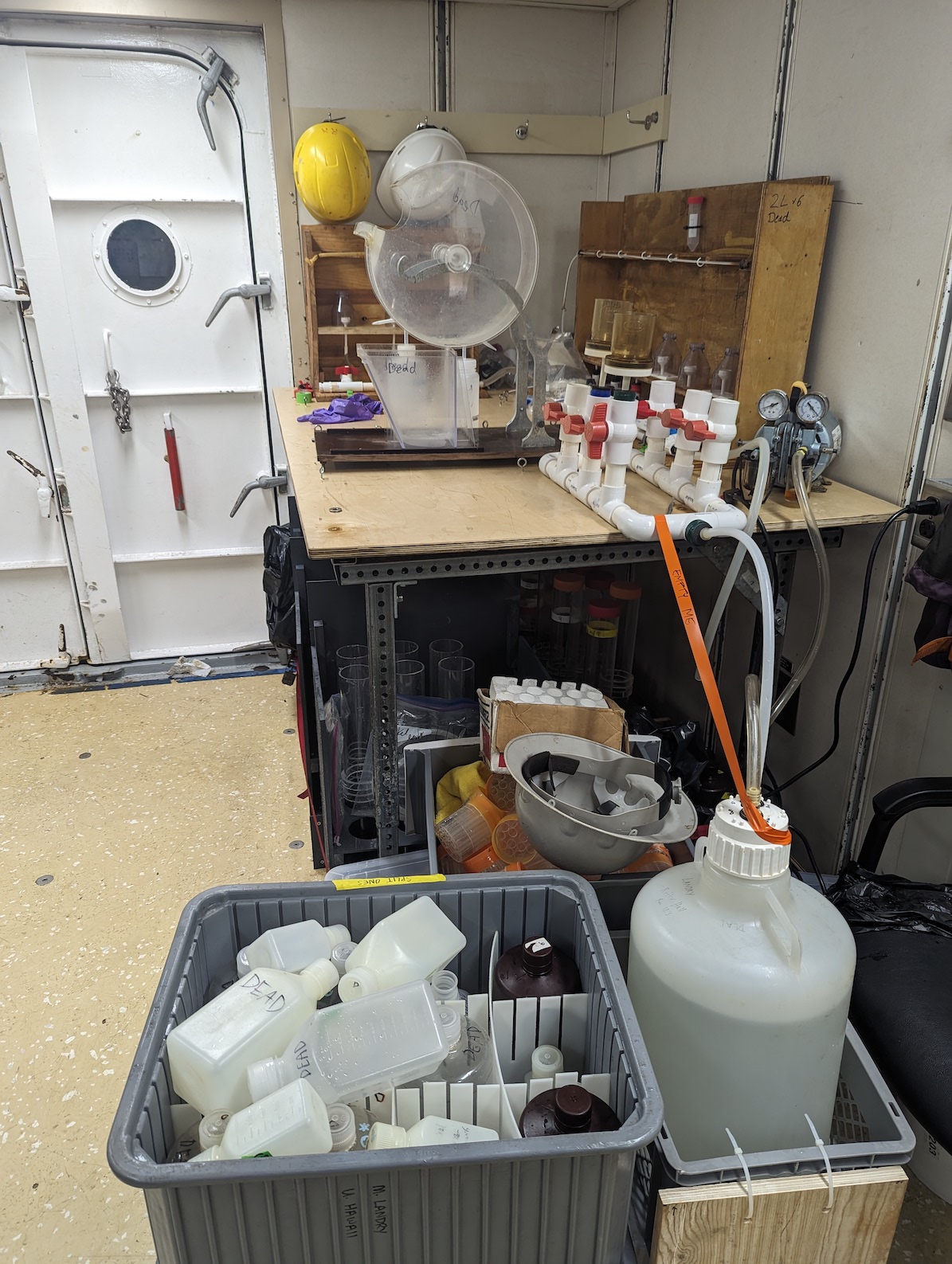 image of a lab table with splitters, filters and a bunch of bottles, all labeled dead