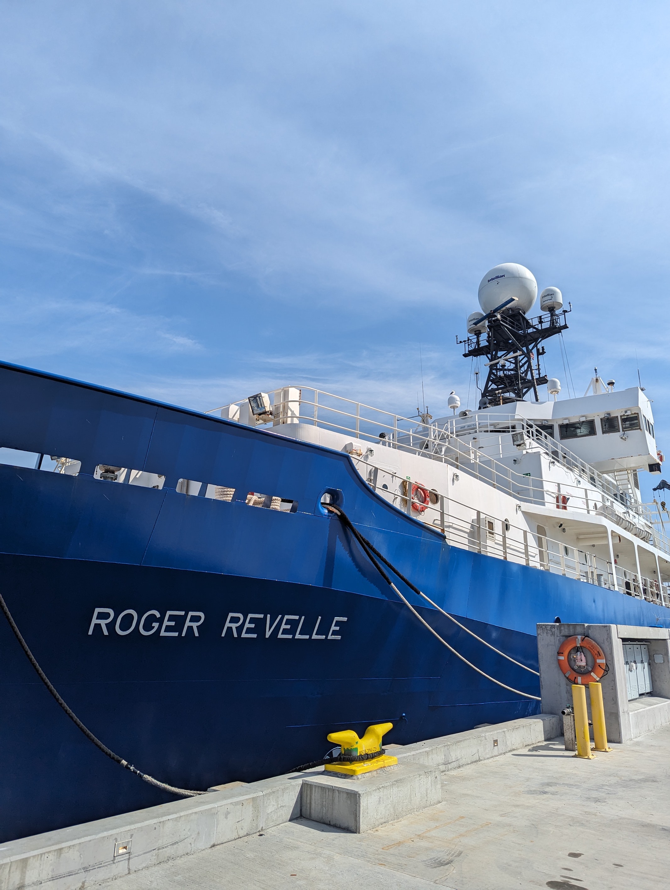 side image of r/v roger revelle, blue-hulled ship with white writing on the side, and assorted scientific instruments on top.