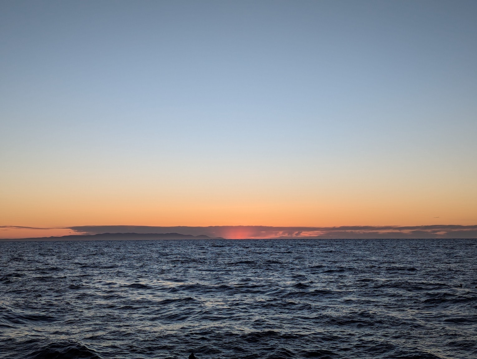 sunrise with pink streaks over the ocean