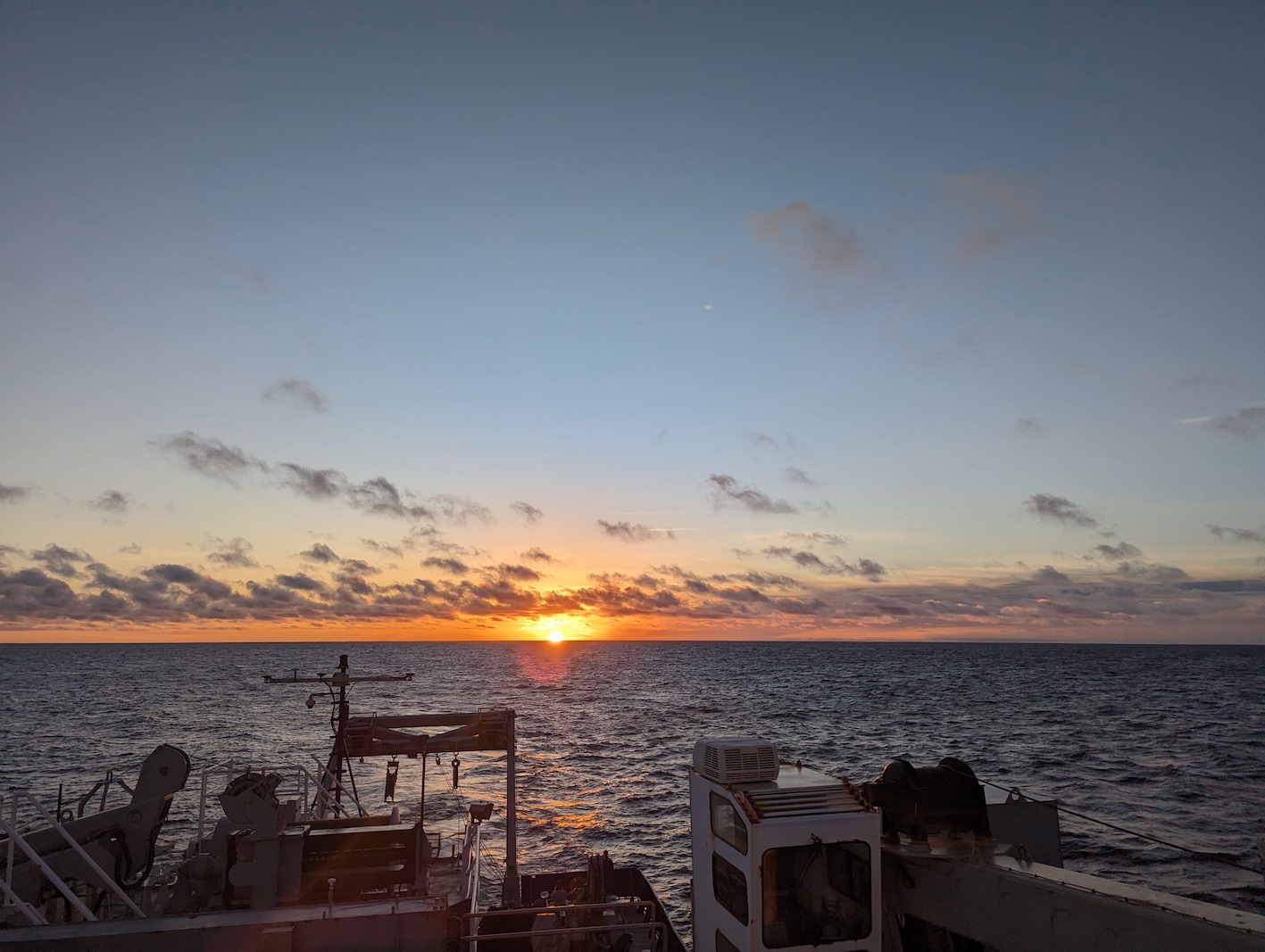 sunset over the ocean with streaky clouds